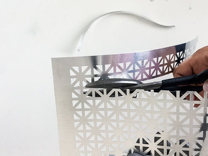 Cutting a decorative metallic sheet to make a DIY jewelry holder