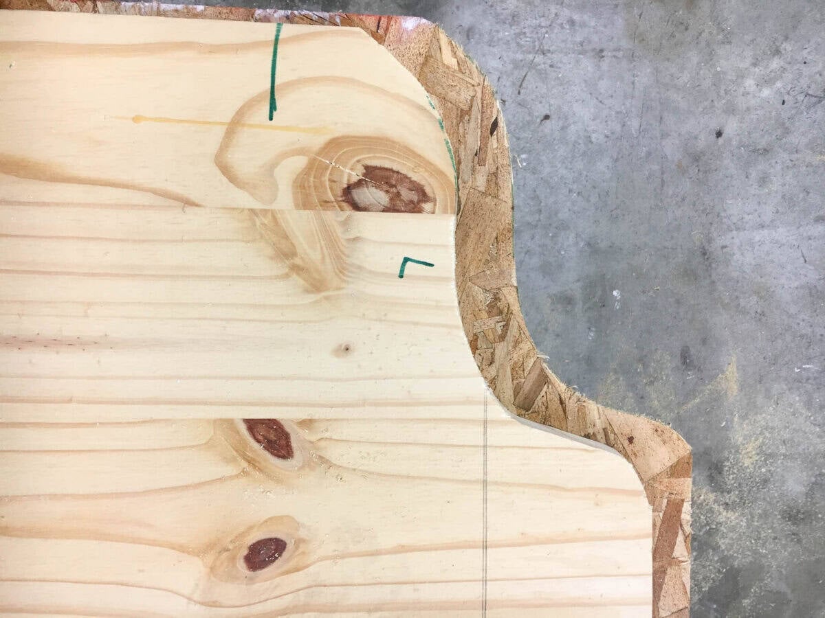 close up of the cutout of the edge of the headboard in plywood.