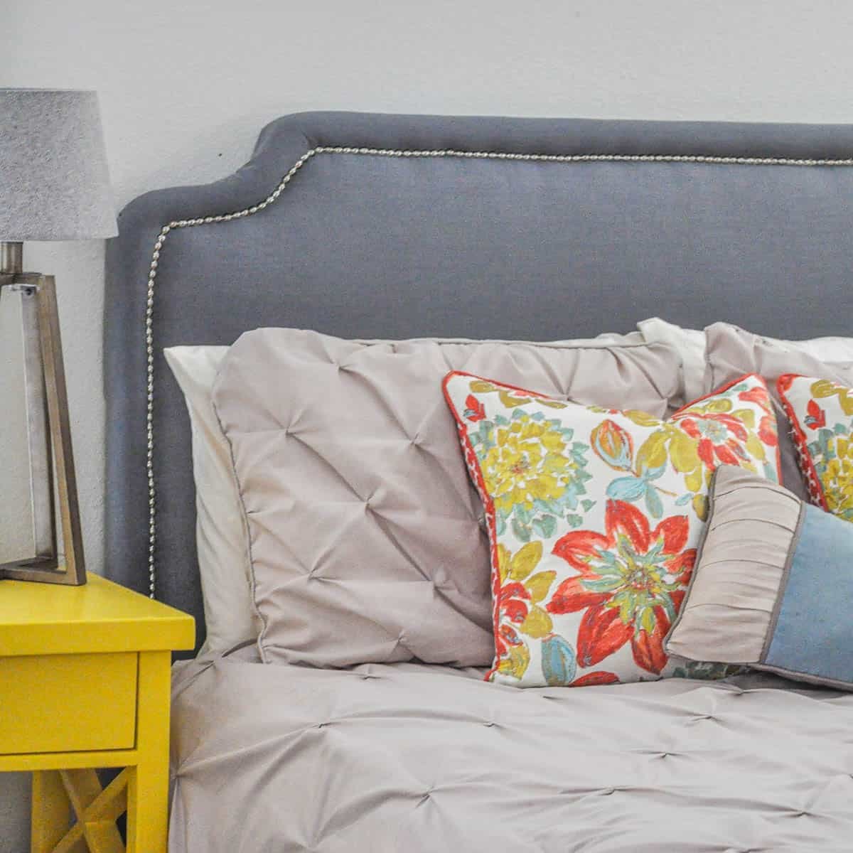 Build your dream DIY upholstered headboard for under $60! This step-by-step tutorial shows you how to get a high-end look with nailhead trim on a budget.