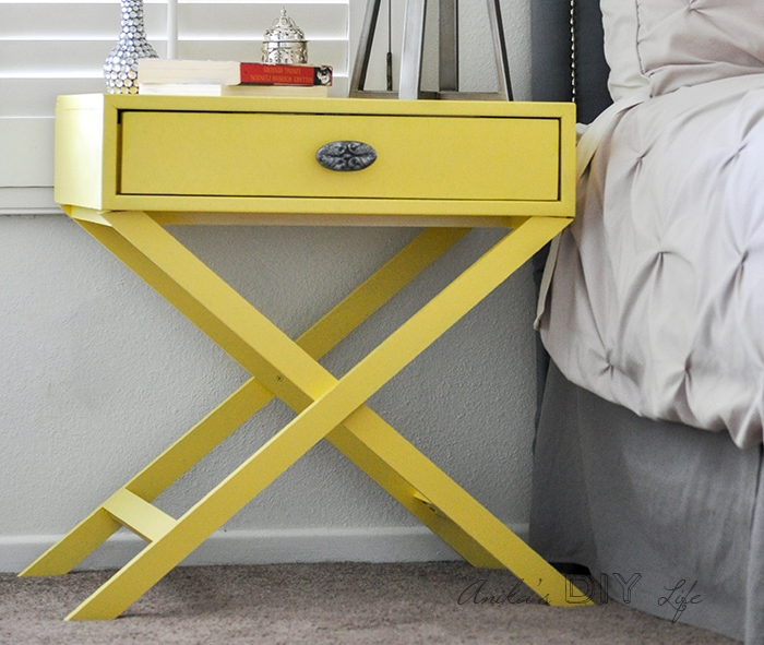 Yellow DIY X-leg accent table nightstand next to bed