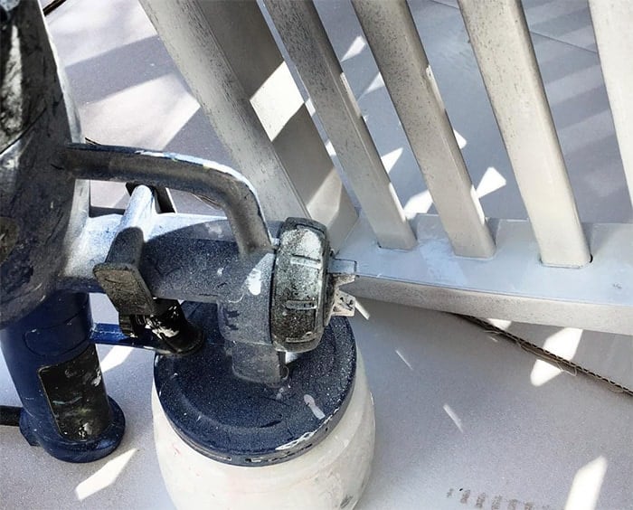 Applying primer to outdoor wood furniture using a paint sprayer