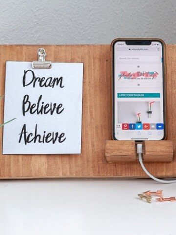 Brown DIY phone holder with phone and quote in a clip