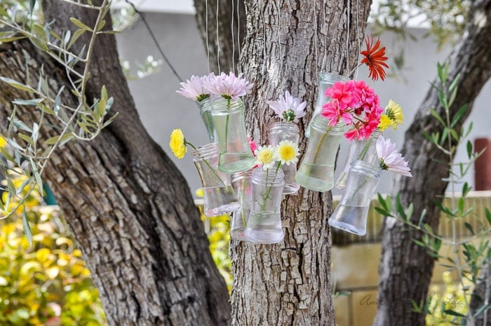 make your own wind chime and outdoor decor with this recycled glass bottle decor idea