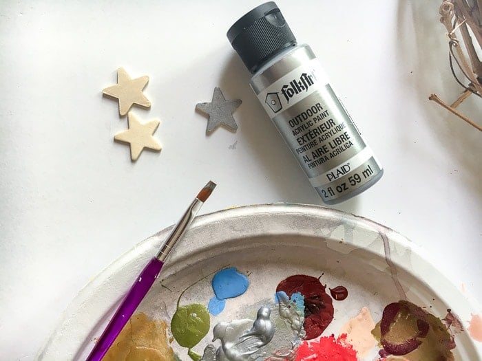 Painting silver stars to add to easy dollar store patriotic wreath