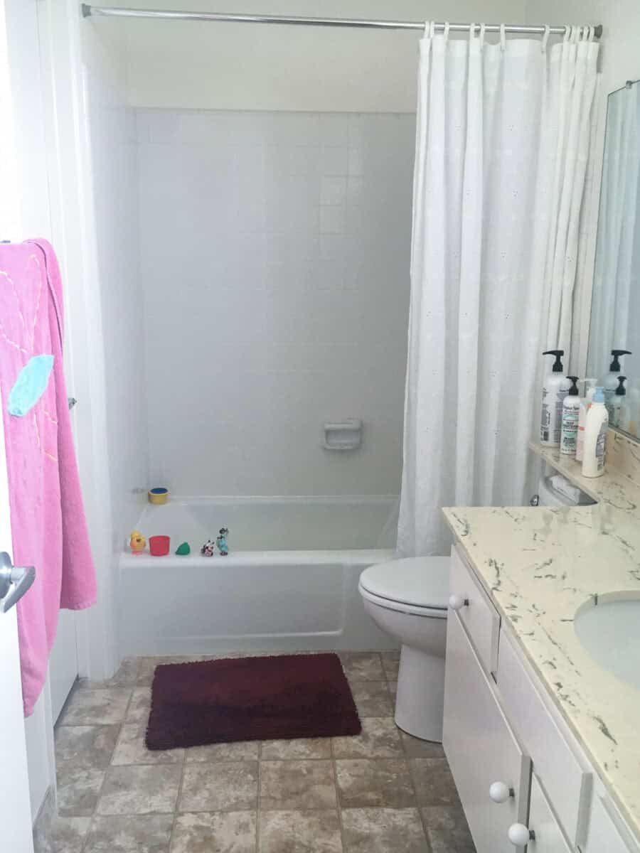 Rental bathroom makeover before with yellow countertop.