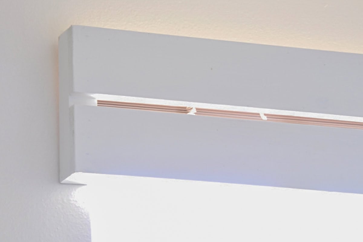 DIY Wood valence to cover up old pink blinds.