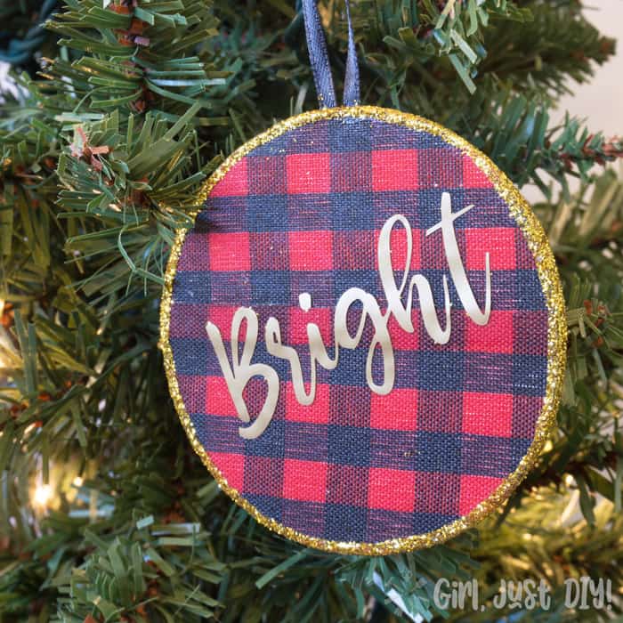 Red and blue plaid circular ornaments on Christmas tree