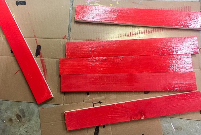 1x3 boards painted red and waiting to dry