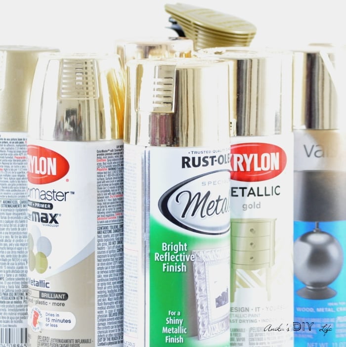 Cans of gold spray paint gathered.