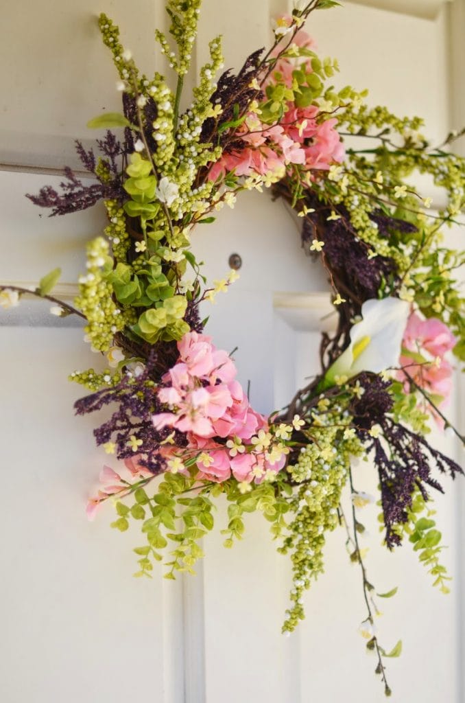 Grapevine wreath with faux greenery and pink flowers
