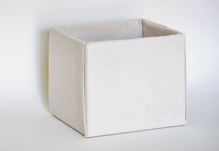 How to make perfect no-sew canvas storage bins by wrapping cardboard boxes in drop cloth. This is a fun easy drop cloth organization project
