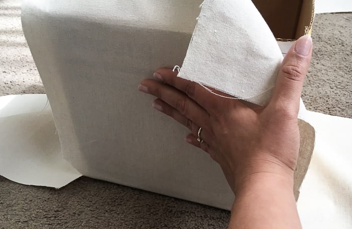 How to make perfect no-sew canvas storage bins by wrapping cardboard boxes in drop cloth. This is a fun easy drop cloth organization project