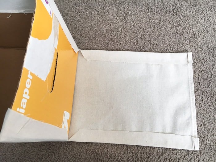 How to make perfect no-sew canvas storage bins by wrapping cardboard boxes in drop cloth. This is a fun easy drop cloth organization project