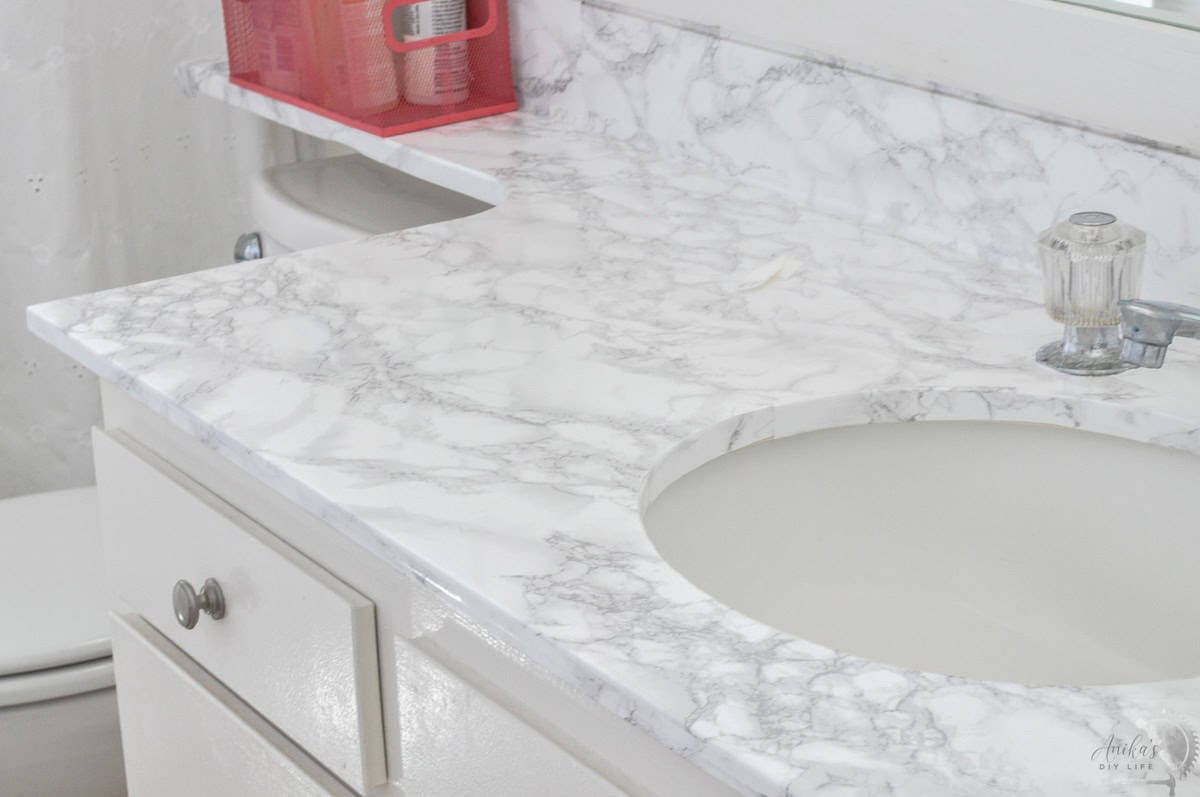 White marble contact paper on a bathroom countertop.