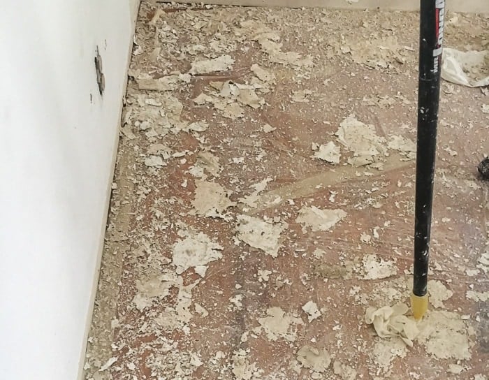 Floor covered in popcorn ceiling after stripping.