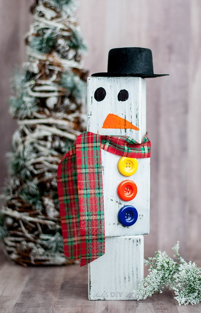 Wood block snowman in front of little Christmas tree