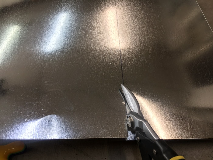 Cutting sheet metal with tin snips