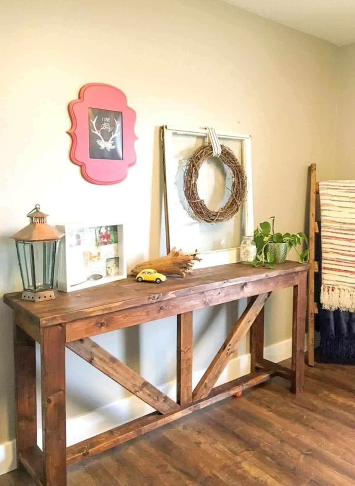 Console table made with 2X4s against a wall in the living room