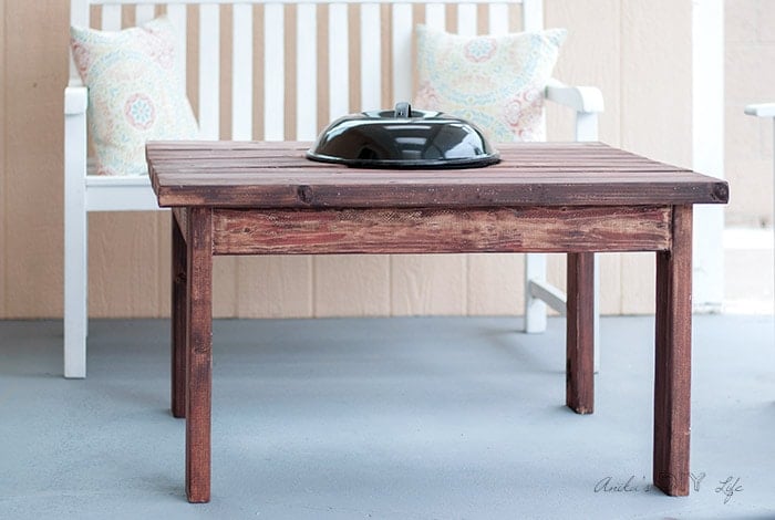 A DIY Patio table with fire pit with lid on in the patio