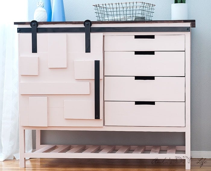 Pink DIY sliding barn door cabinet with stained top in office space