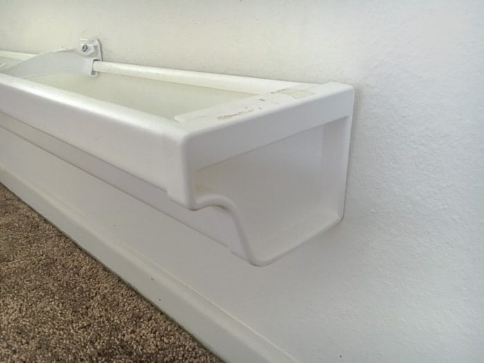 End caps installed on rain gutter bookshelves.