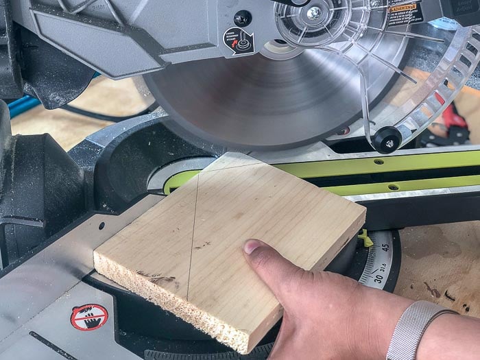 Cutting DIY Christmas village houses out of scrap wood on the miter saw