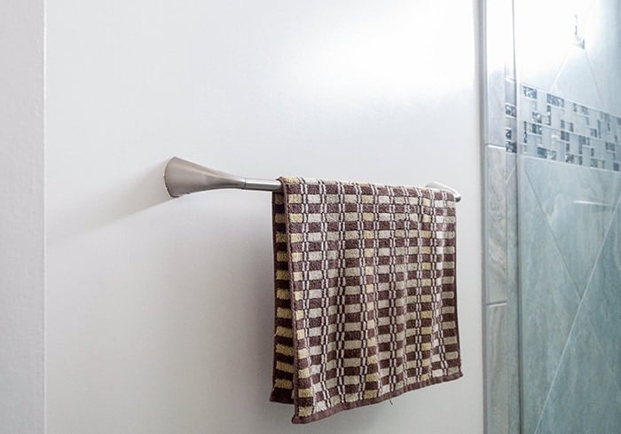 Old towel rod with towel on it