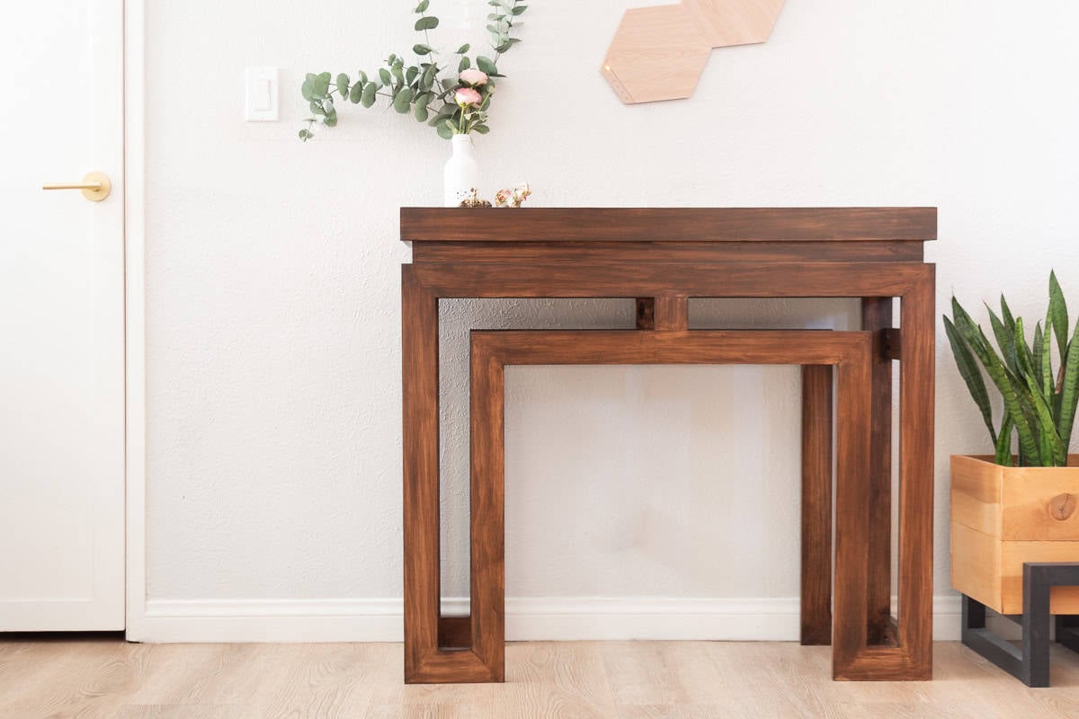 Brown Modern  DIY console table in front of gray wall next to plants