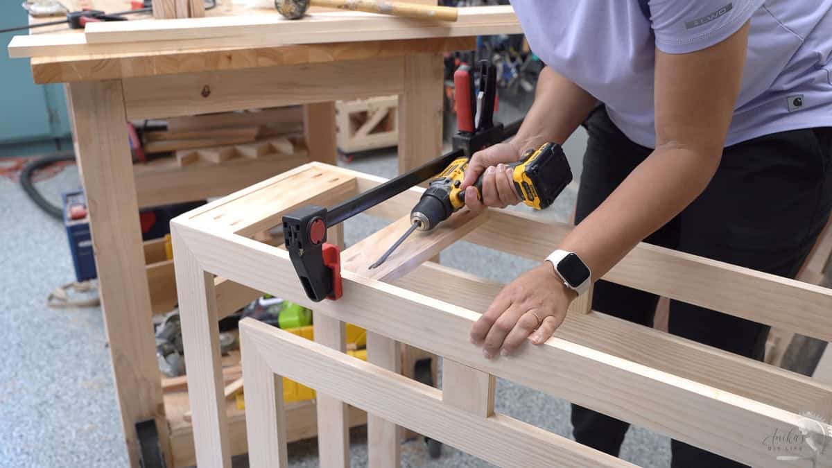 attaching the support slats to the console table using pocket hole screws