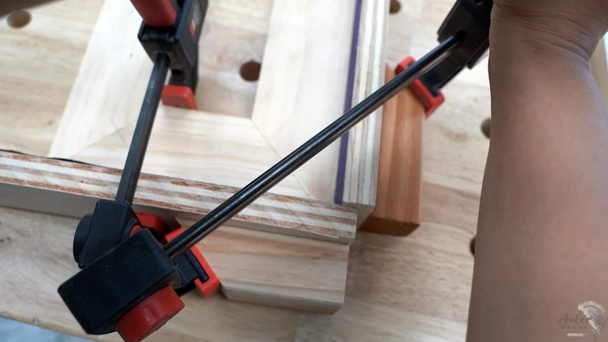 a mitered dowel joint clamped together using a special clamping jig for mitered corners