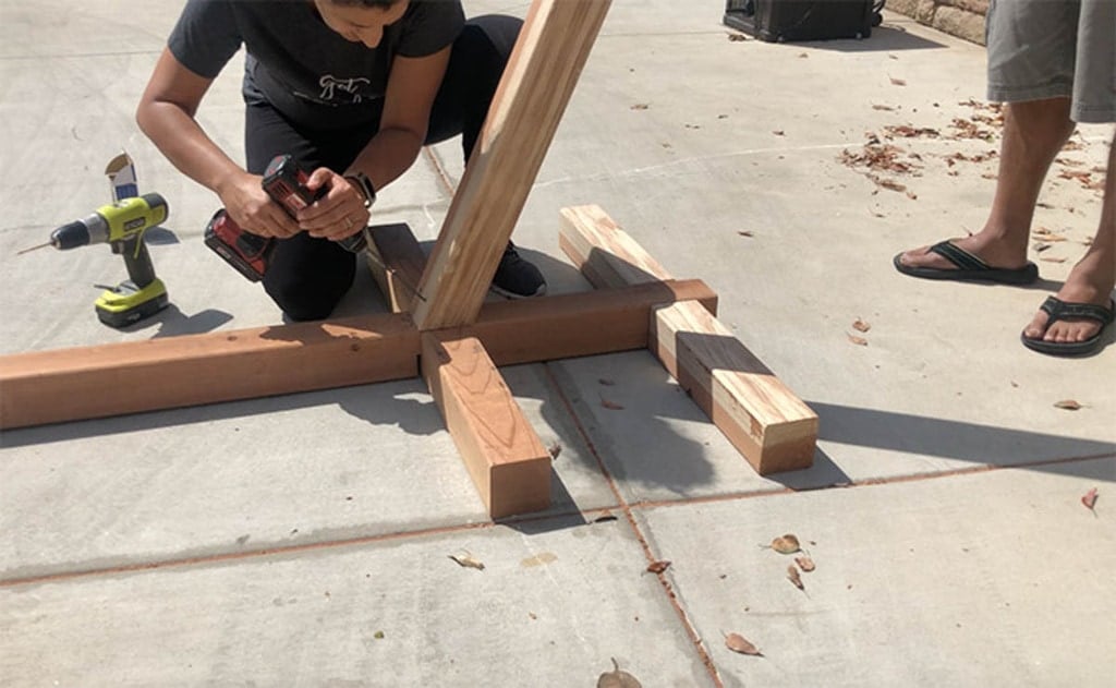 Attaching the uprights for the hammock stand made with 4x4