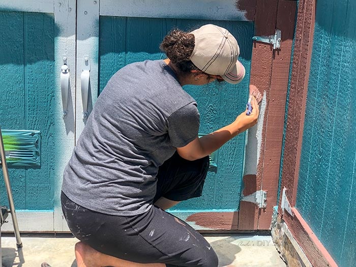 Painting trim of the outdoor shed