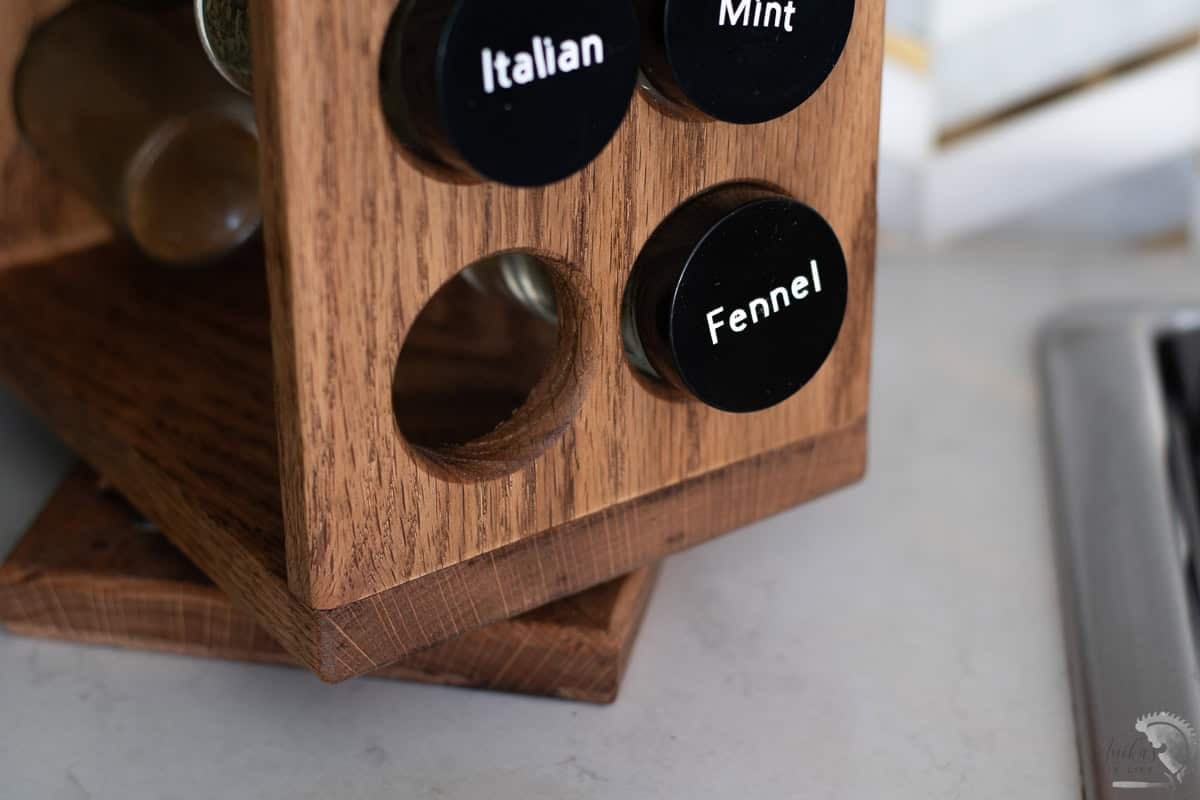 Close up of the diy rotating spice rack holes for the spice bottles.
