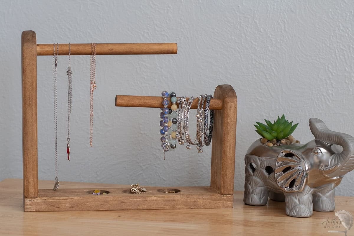 DIY tabletop jewelry holder on the table with jewelry hanging