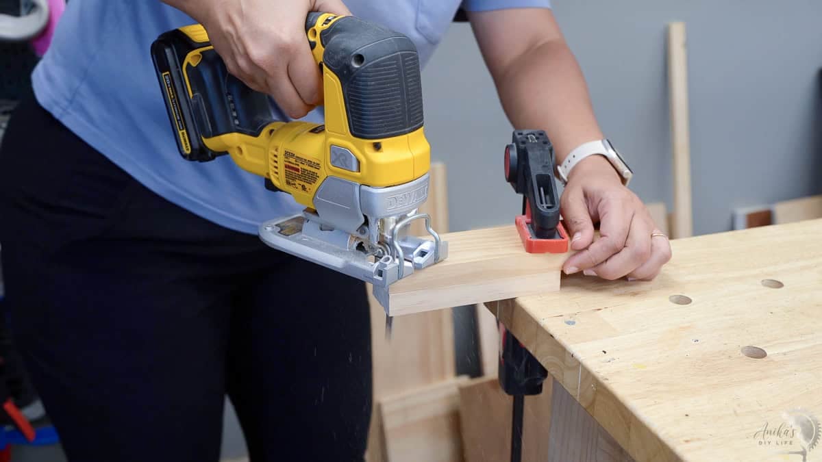 cutting the arc on the top of the tabletop DIY jewelry holder with a jigsaw