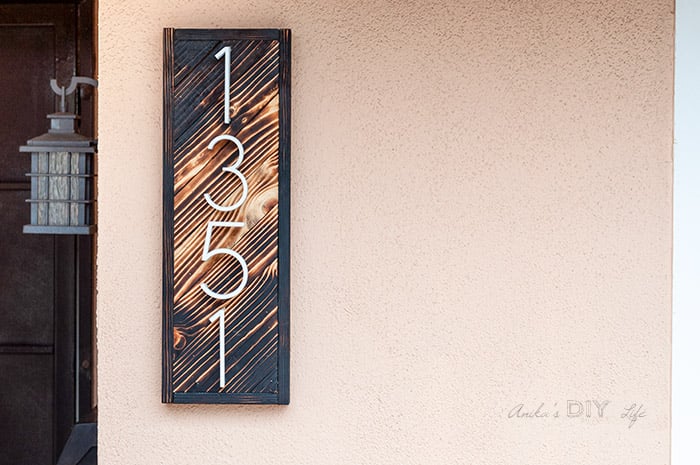 DIY house number sign with gradient wood burning on the wall