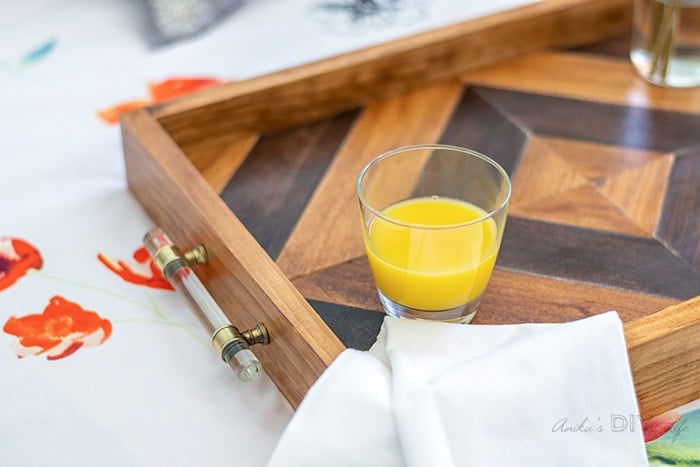 close up of the DIY wood tray with cup of orange juice on it