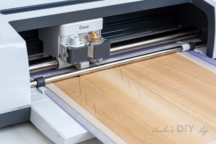 Cricut maker cutting christmas ornaments out of basswood