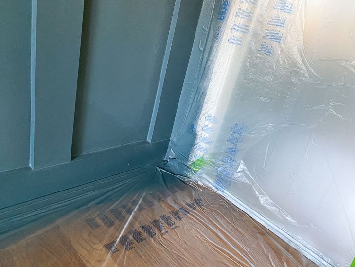 painted board and batten wall with overspray on plastic