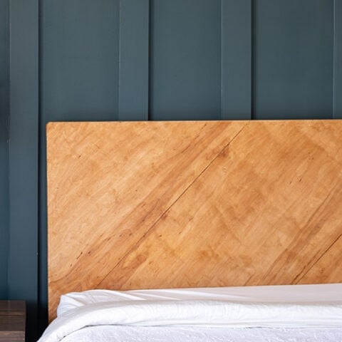 This simple and easy DIY plywood headboard is made with one sheet of plywood and a few 2x4s. Learn how to make a headboard in a weekend.