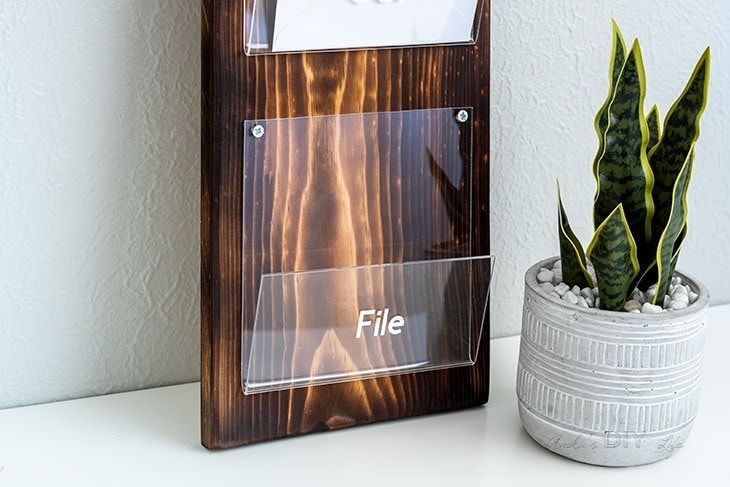 close up of bent acrylic and wood mail organizer