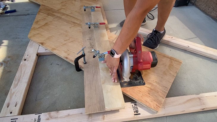 cutting the extra plywood from the headboard