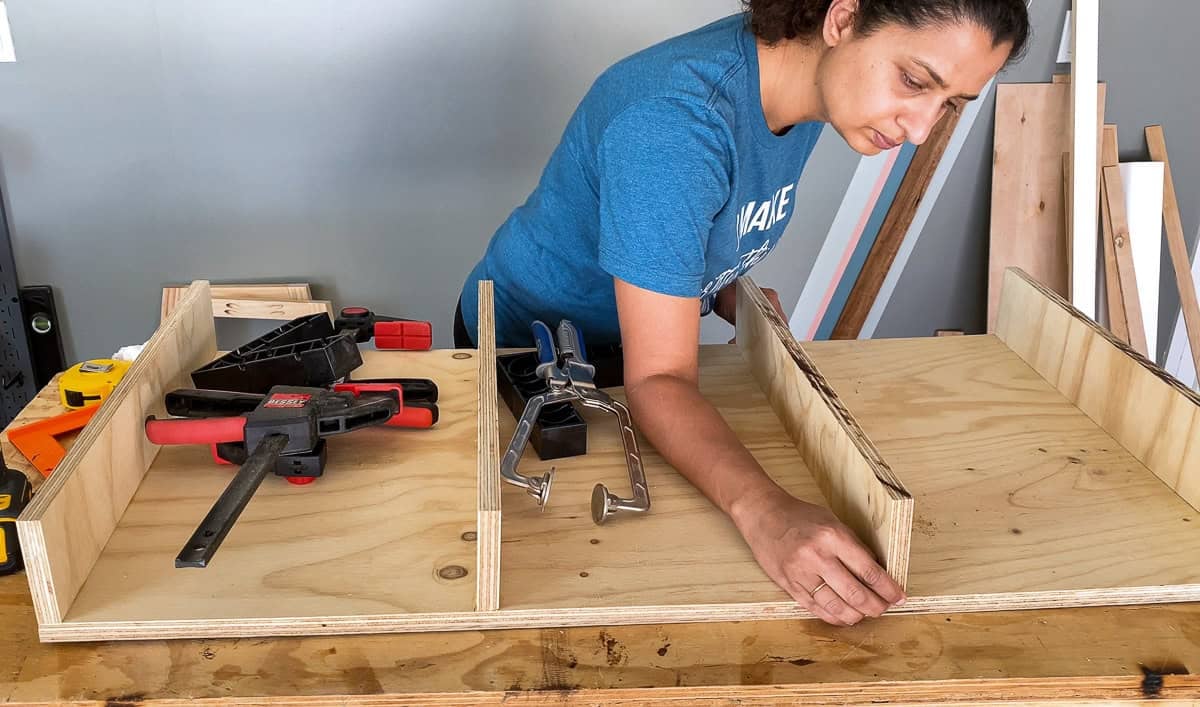 Anika Attaching the divider boards to the plywood to form the box for the desk