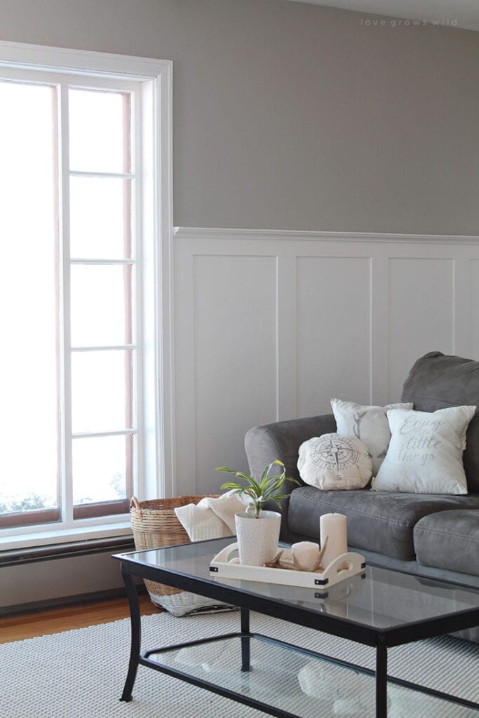 half baord and batten wall in living room with gray couch