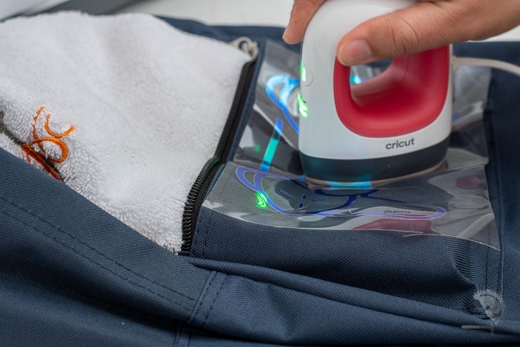 applying iron on onto a backpack