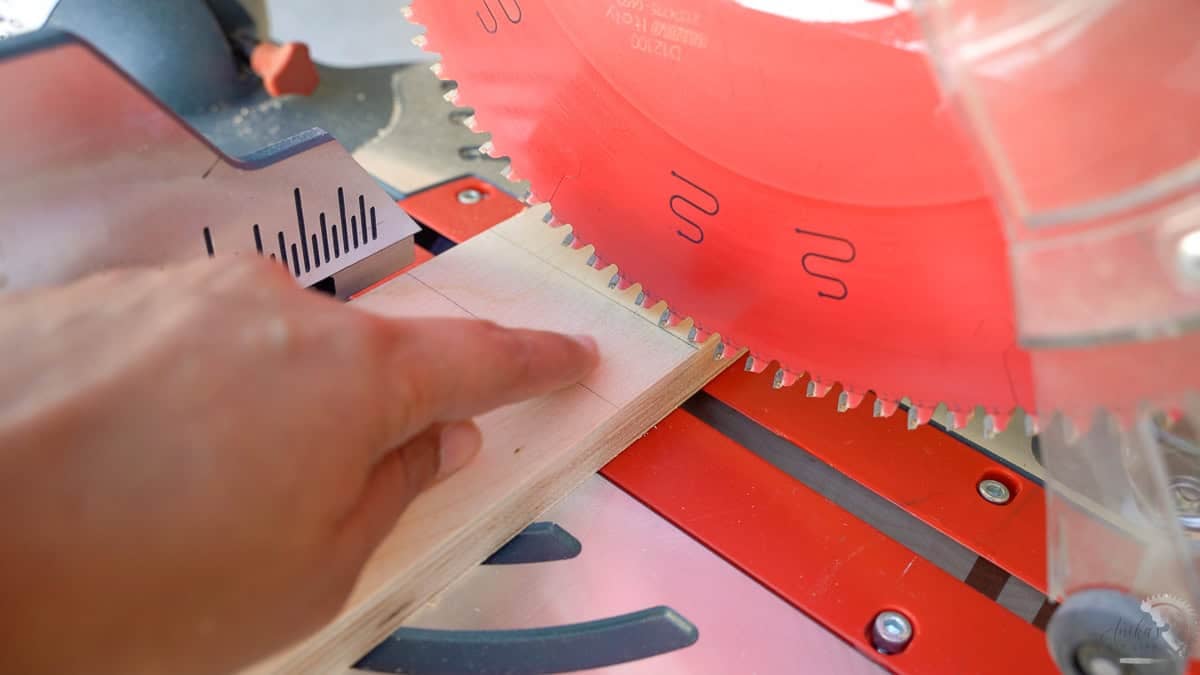 showing how to align the blade on a miter saw to the cut line to get accurate cuts on a miter saw.