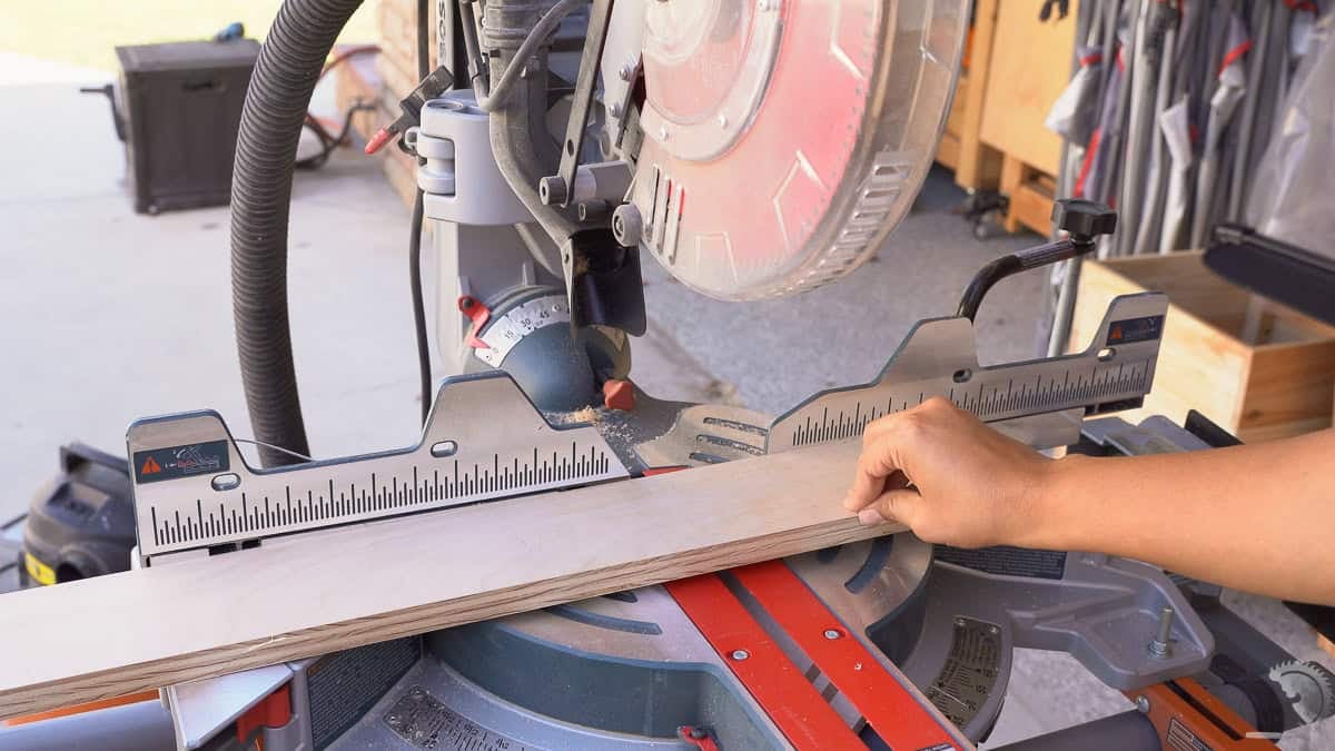 showing how a long unsupported board can be wobbly at the miter saw