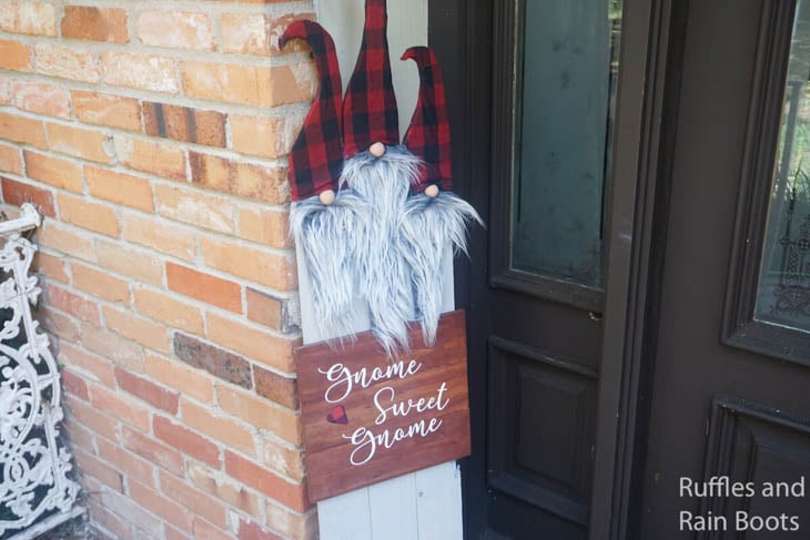 3 gnomes with red and black santa hats made on scrap wood
