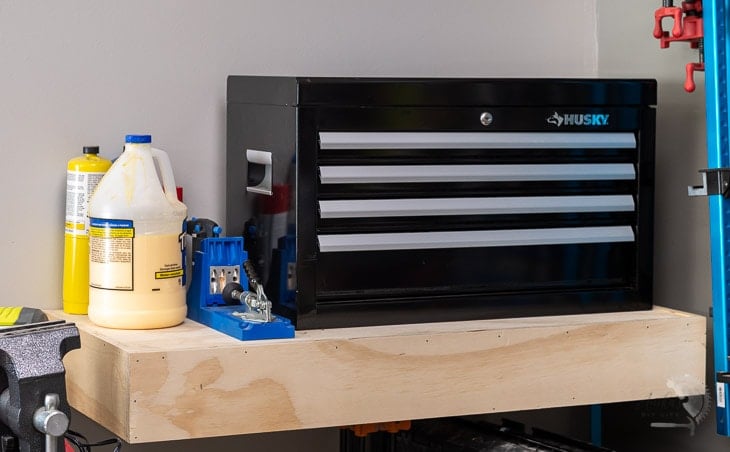 Heavy Duty DIY floating shelf in garage with toolbox on it