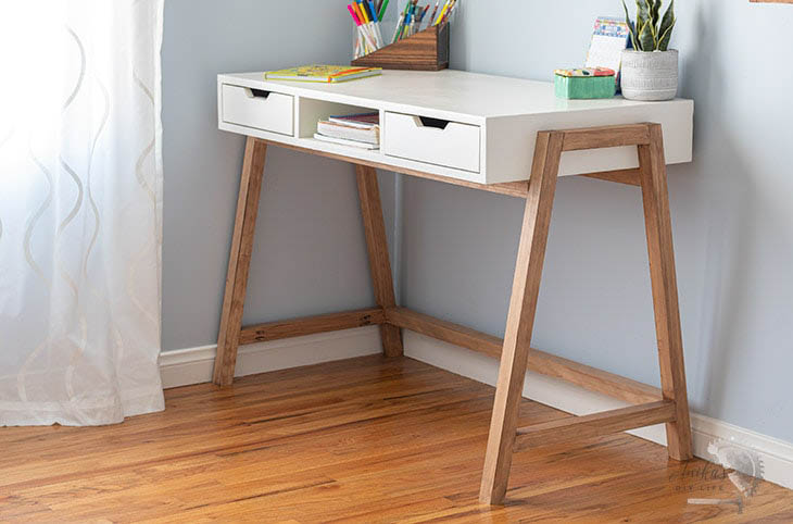 DIY A-frame desk in room with accessories on top.